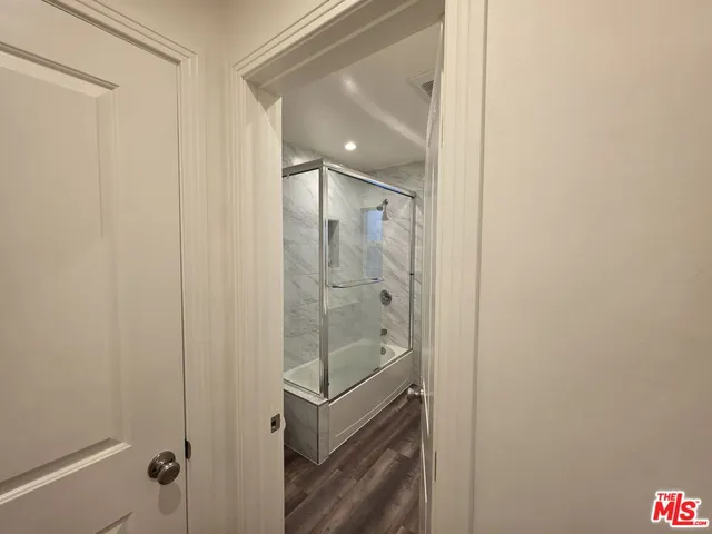 a bathroom with a glass shower door