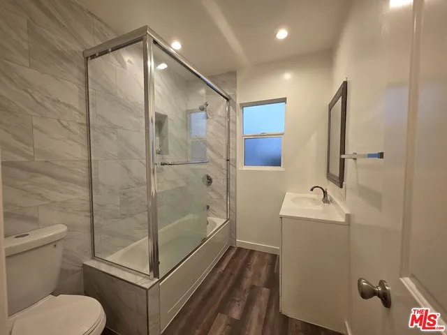 a bathroom with a shower toilet and sink