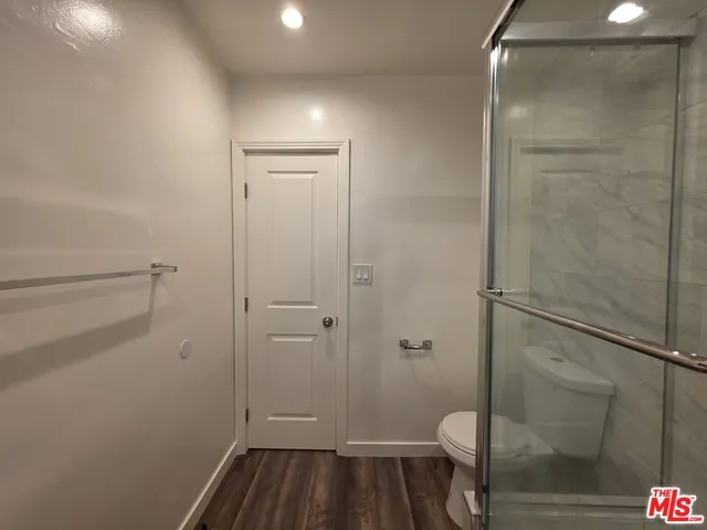 a bathroom with a shower and toilet