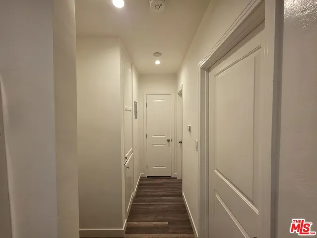 a view of a hallway with a wooden floor