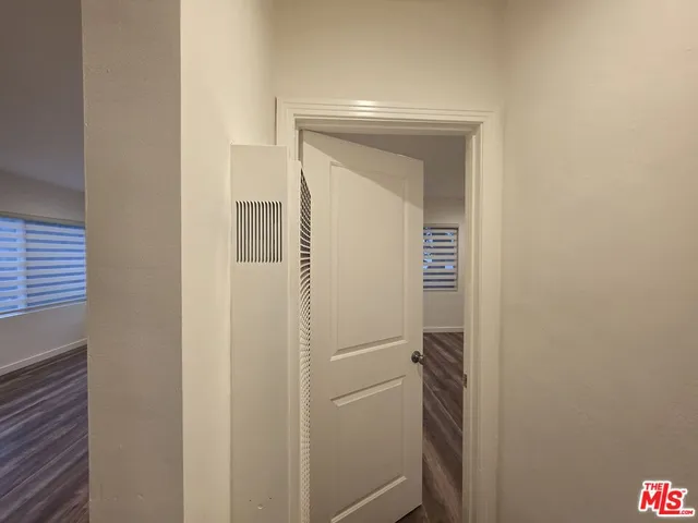 a view of room with window and wooden floor