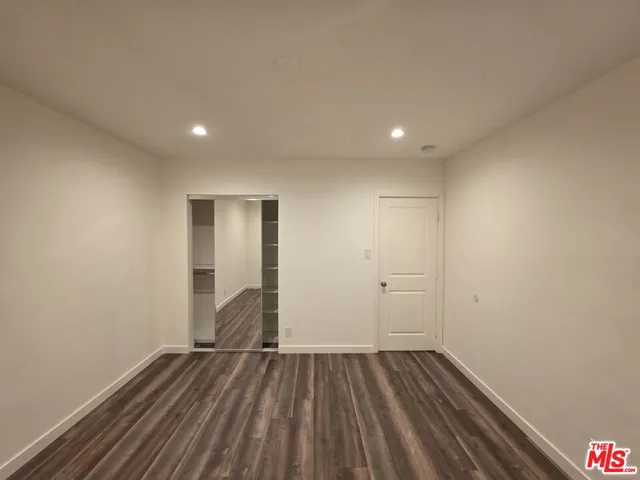 a view of room with window and hardwood floor
