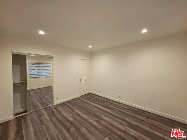 a view of room with wooden floor