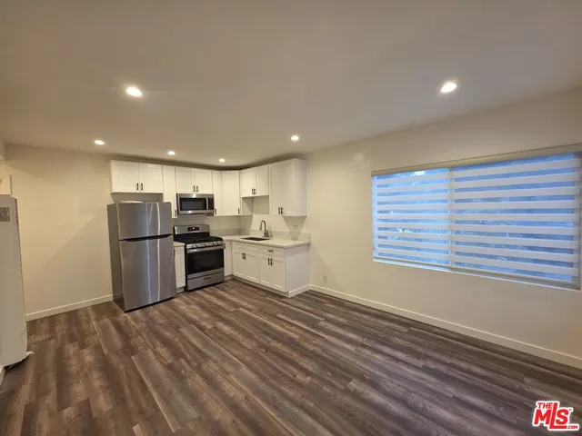 a kitchen with stainless steel appliances granite countertop a stove and a refrigerator