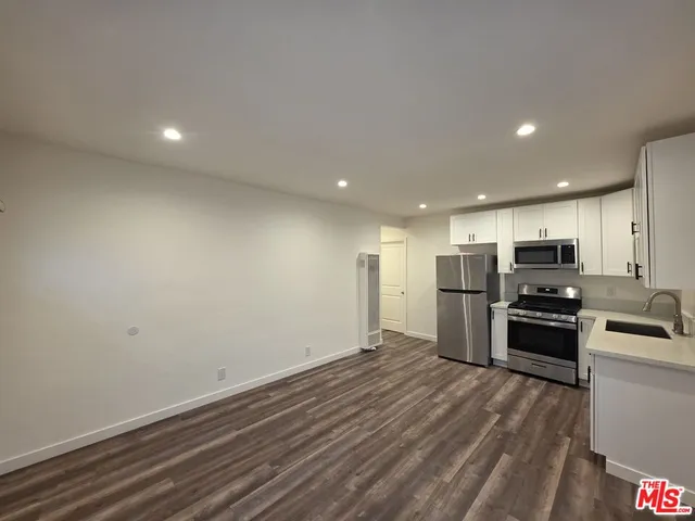 a view of kitchen with refrigerator microwave and stove