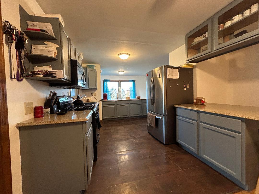 10598 North 3500W Road Manteno, IL 60950 - Photo 9 of 56 a kitchen with stainless steel appliances granite countertop a refrigerator a stove top oven a sink and dishwasher
