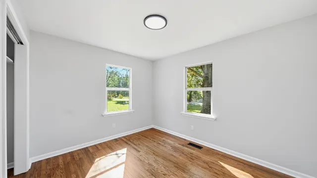 a view of an empty room with a window and a window
