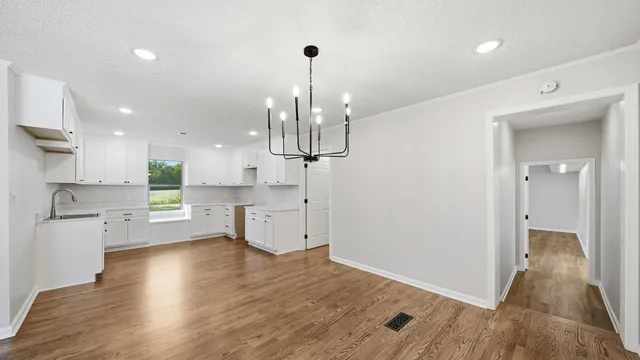 a kitchen with stainless steel appliances granite countertop wooden floors sink and cabinets