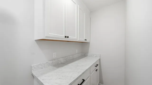 a utility room with a sink and cabinets