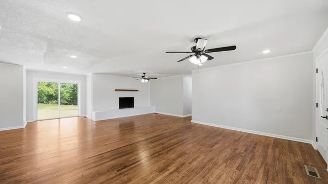 wooden floor in an empty room with a window