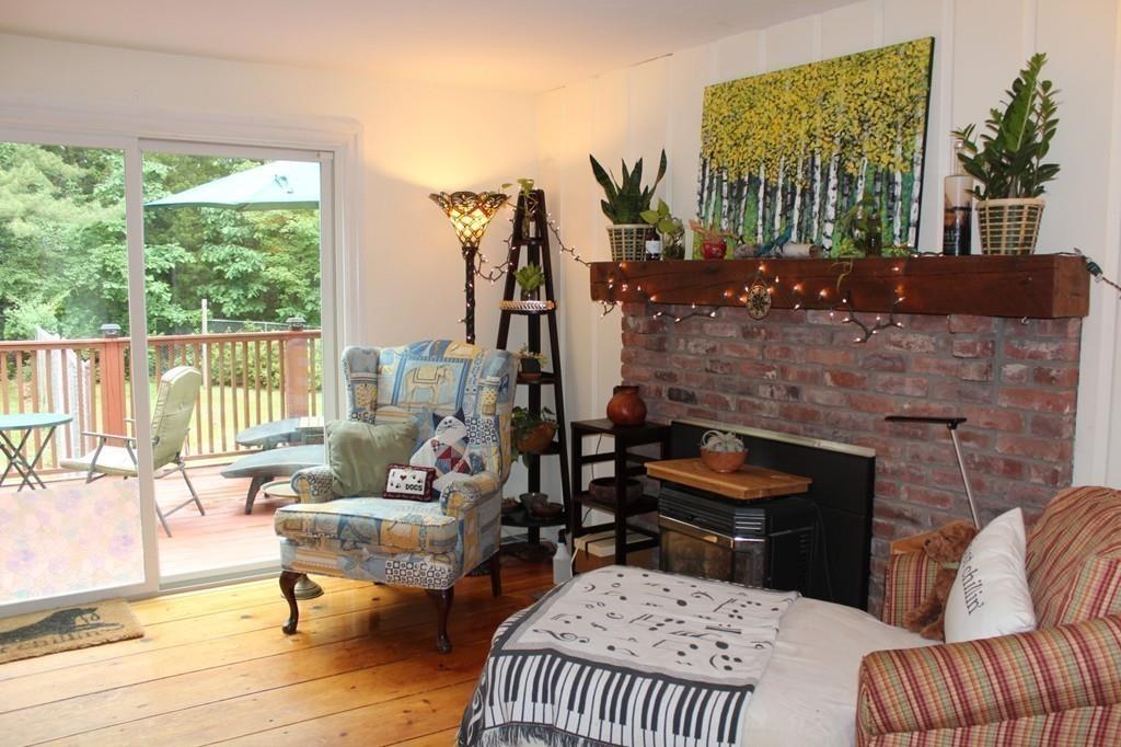 63 Grove Street Upton, MA 01568 - Photo 11 of 42 a living room with furniture and a floor to ceiling window
