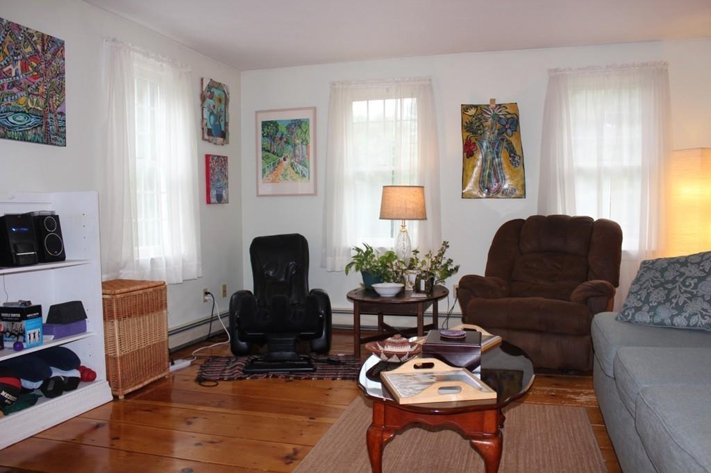 63 Grove Street Upton, MA 01568 - Photo 14 of 42 a living room with furniture fireplace and a window