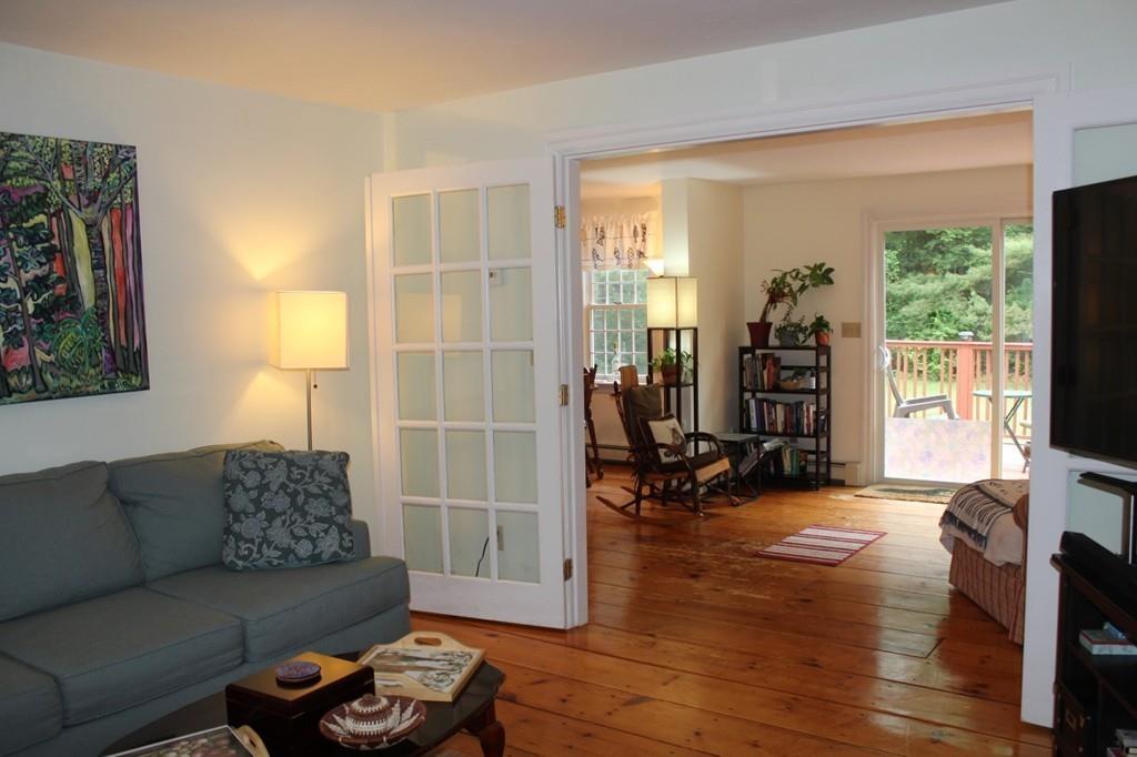 63 Grove Street Upton, MA 01568 - Photo 15 of 42 a living room with furniture and a flat screen tv with wooden floor