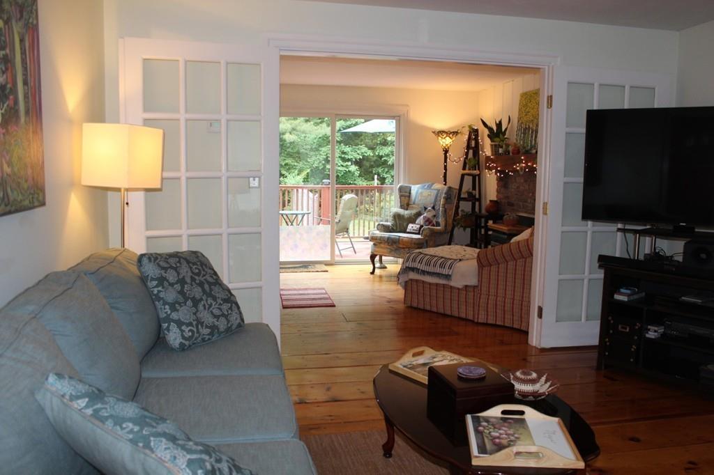 63 Grove Street Upton, MA 01568 - Photo 16 of 42 a living room with furniture and a flat screen tv