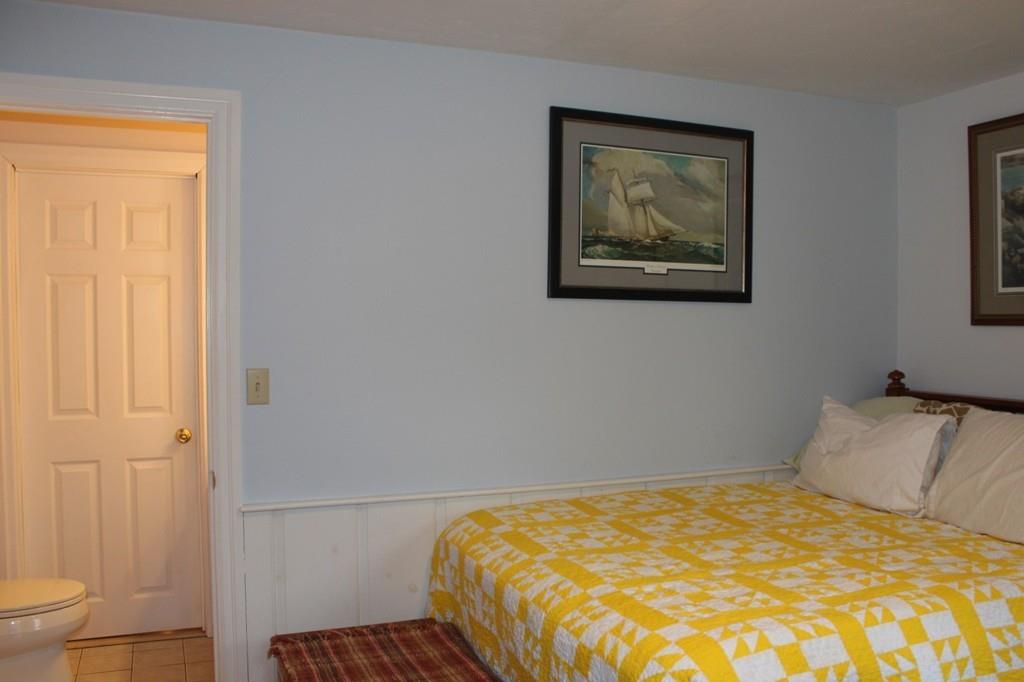 63 Grove Street Upton, MA 01568 - Photo 18 of 42 a bedroom with a bed and a painting on the wall