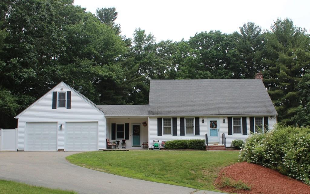 63 Grove Street Upton, MA 01568 - Photo 2 of 42 a front view of a house with a garden and trees