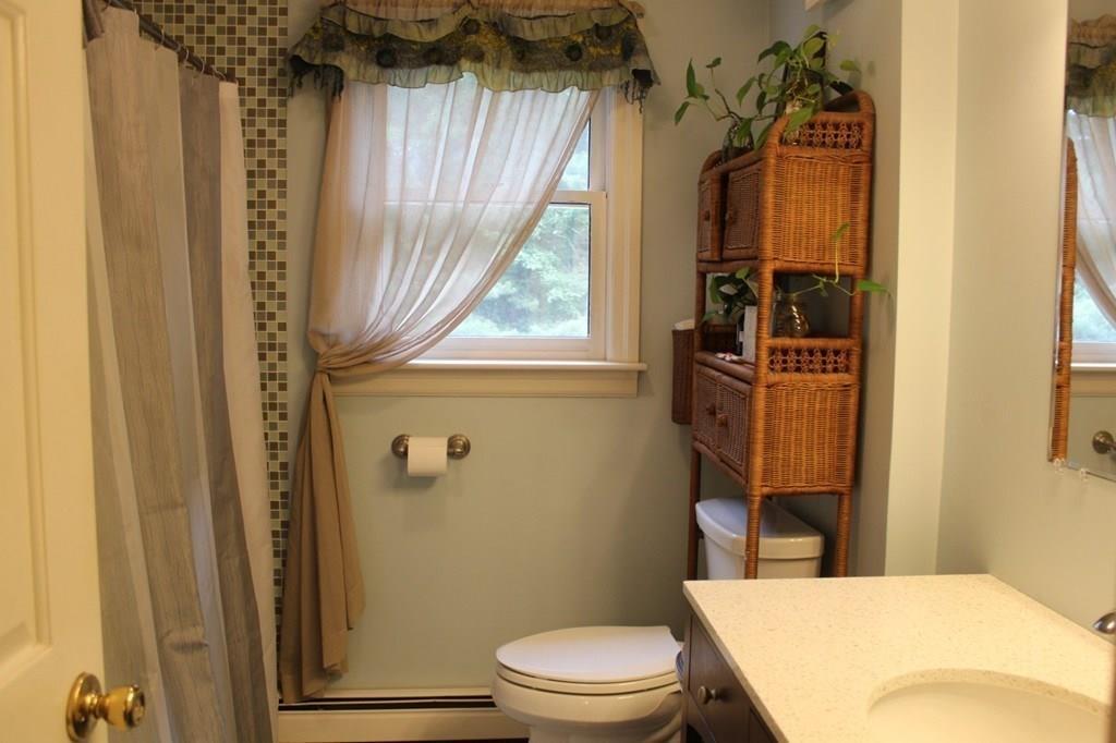 63 Grove Street Upton, MA 01568 - Photo 24 of 42 a bathroom with a toilet a sink and a window