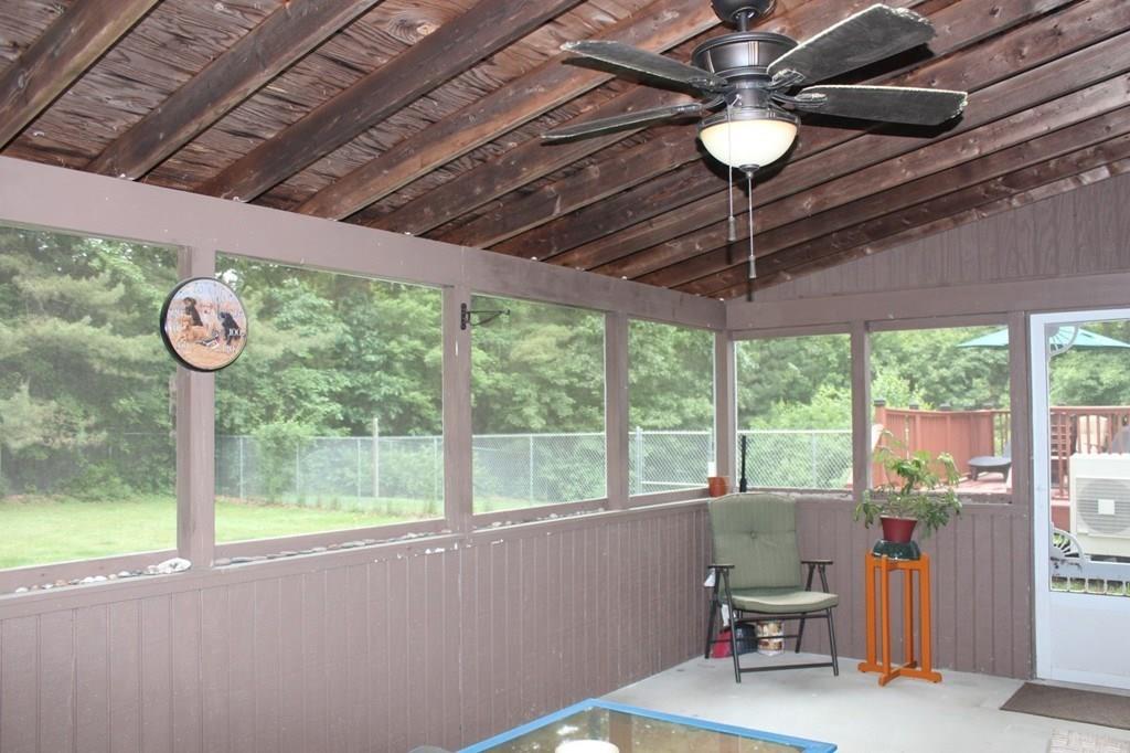 63 Grove Street Upton, MA 01568 - Photo 27 of 42 a roof deck with table and chairs and couches with wooden floor