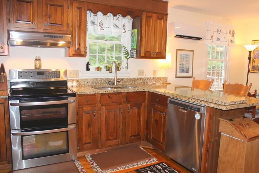 63 Grove Street Upton, MA 01568 - Photo 4 of 42 a kitchen with stainless steel appliances granite countertop a sink stove and cabinets