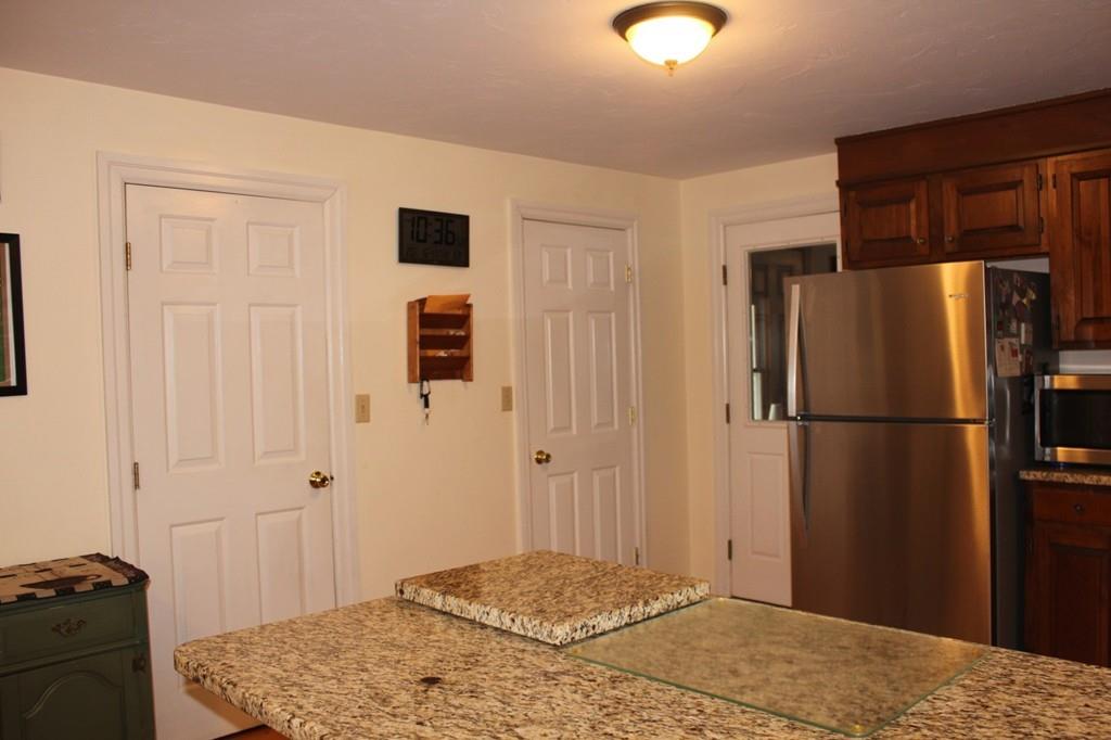 63 Grove Street Upton, MA 01568 - Photo 8 of 42 a bedroom with a bed and a view of kitchen