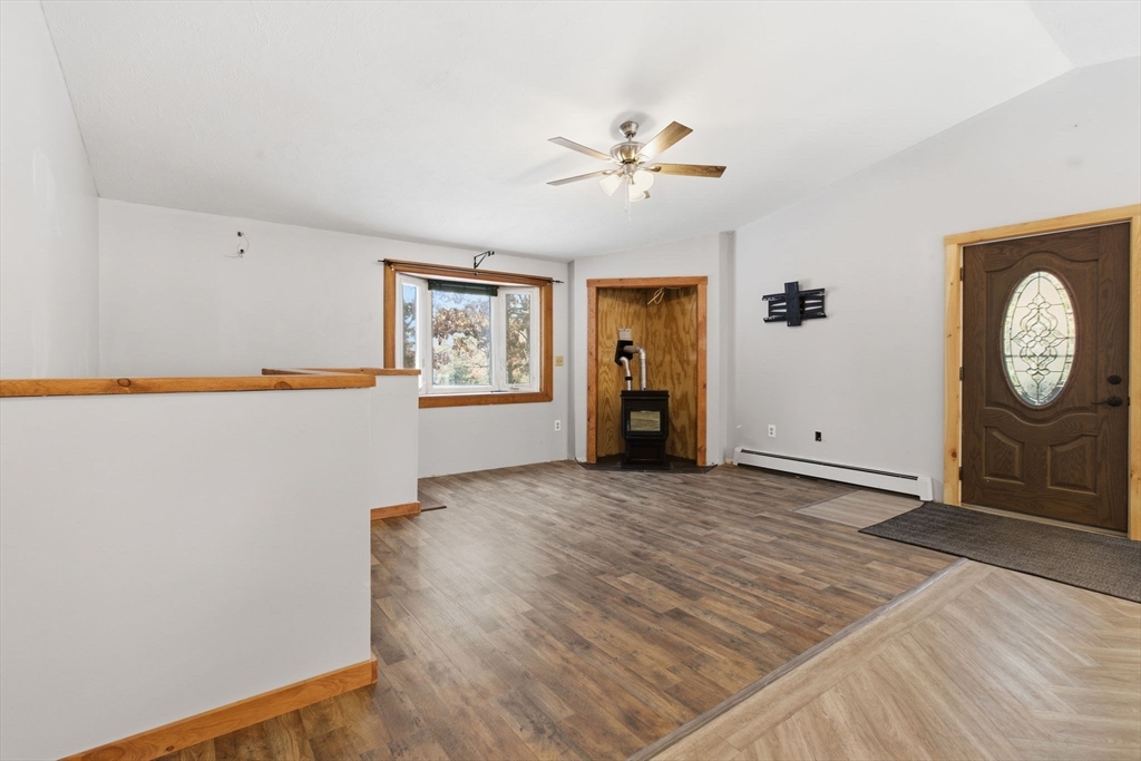 235 Crouch Road Warren, MA 01092 - Photo 12 of 42 a view of a livingroom with wooden floor and a ceiling fan