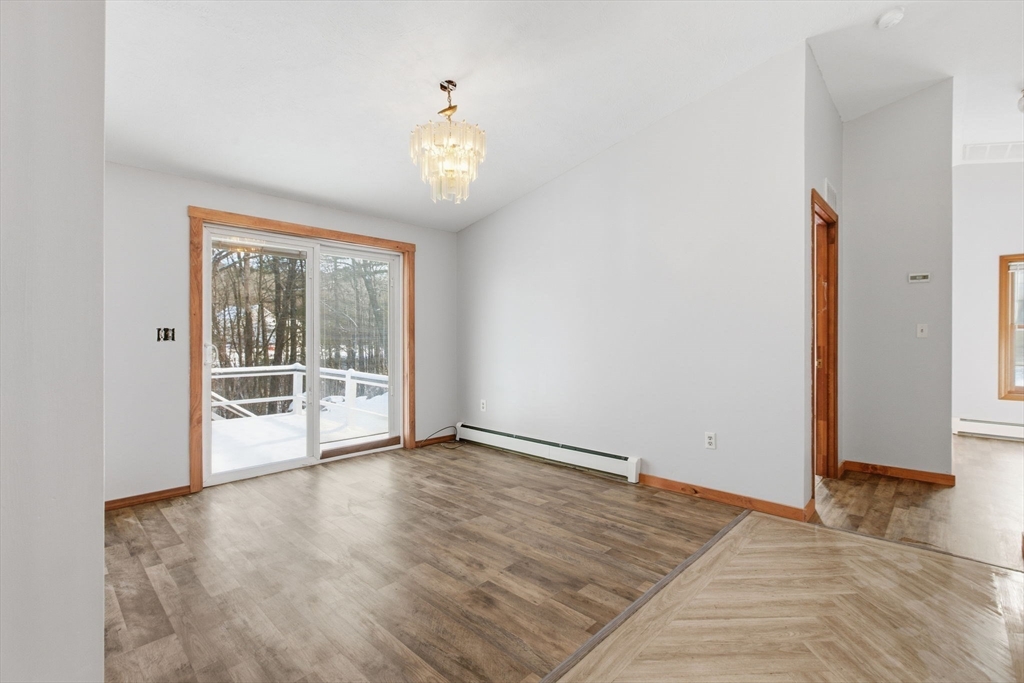 235 Crouch Road Warren, MA 01092 - Photo 18 of 42 an empty room with wooden floor and windows
