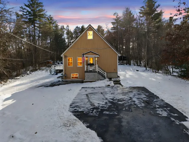 a view of a house with a snow in the yard