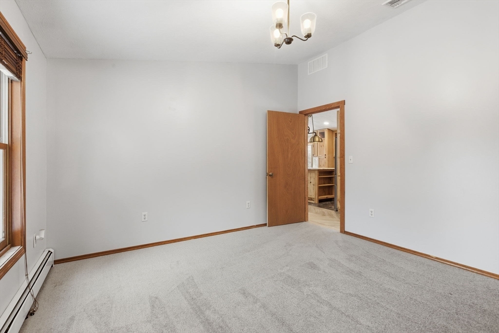 235 Crouch Road Warren, MA 01092 - Photo 24 of 42 an empty room with chandelier fan