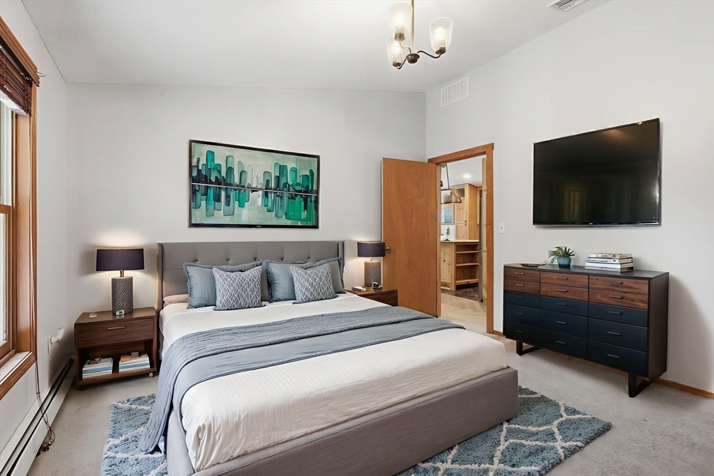 235 Crouch Road Warren, MA 01092 - Photo 25 of 42 a bedroom with a bed and a flat screen tv