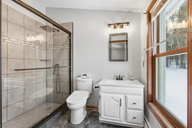 a bathroom with a sink toilet and shower