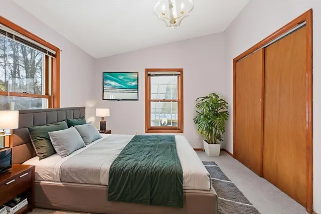 a spacious bedroom with a large bed and a window