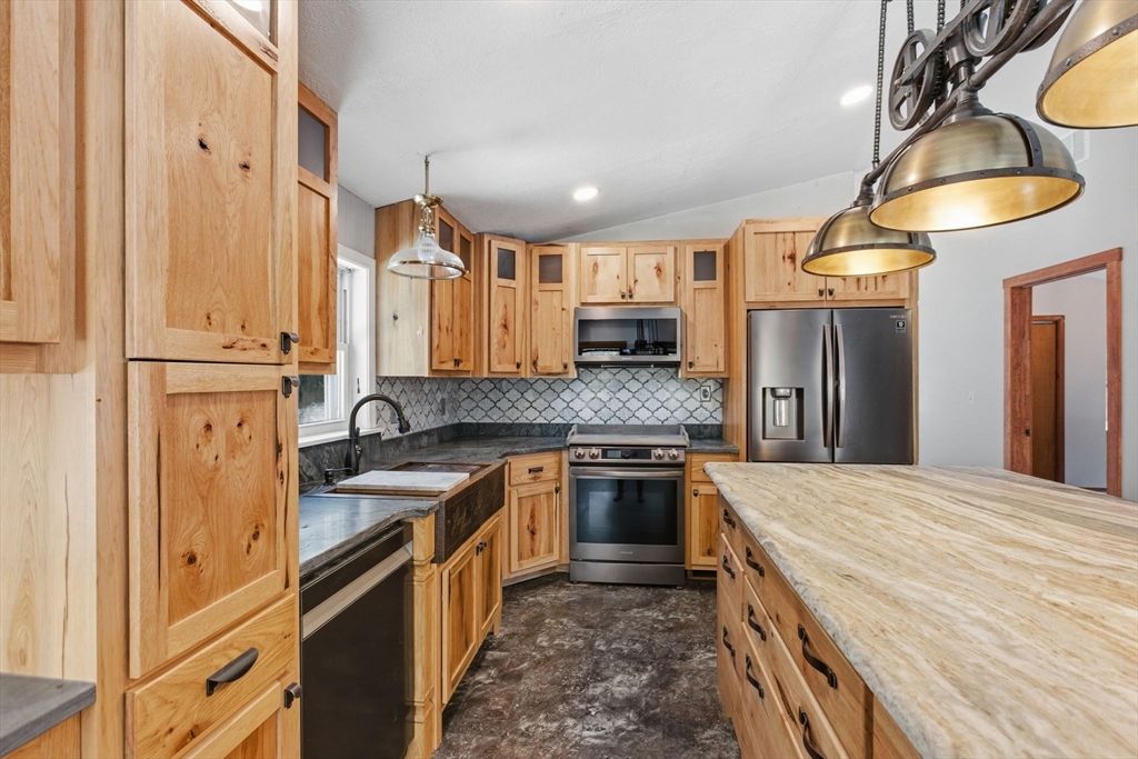 235 Crouch Road Warren, MA 01092 - Photo 6 of 42 a kitchen with stainless steel appliances granite countertop a stove a sink and a refrigerator