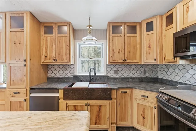 a kitchen with stainless steel appliances granite countertop a stove and a sink