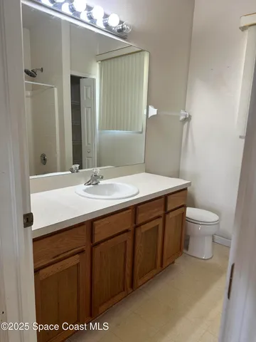 a bathroom with a sink a toilet and mirror