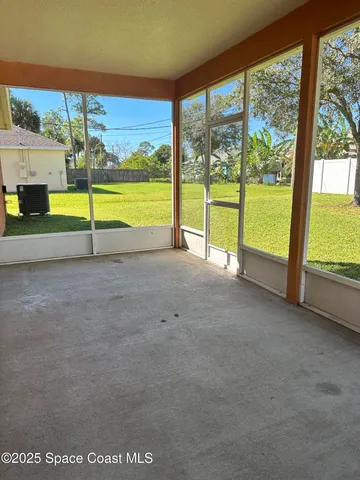 a view of an empty room with a floor to ceiling window