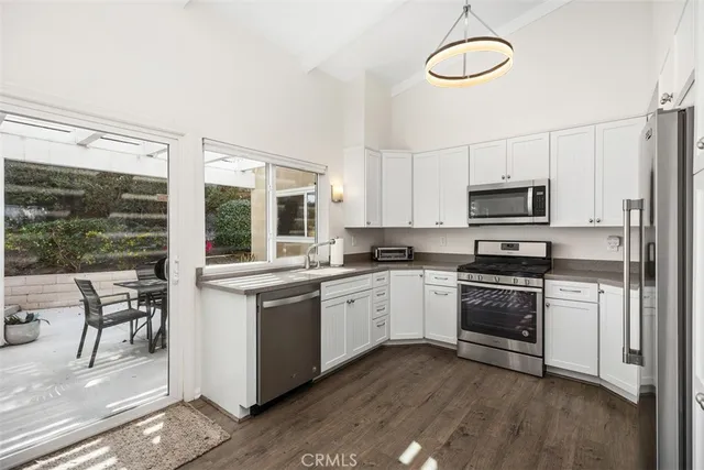 a kitchen with stainless steel appliances granite countertop a stove and a sink