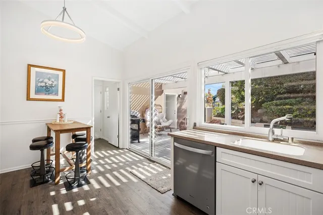 a kitchen with sink refrigerator and large window
