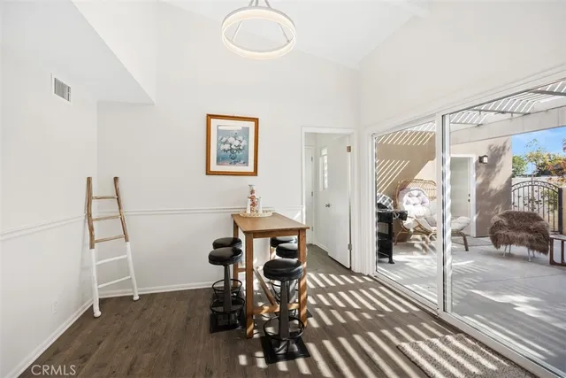 a view of a room with furniture and wooden floor