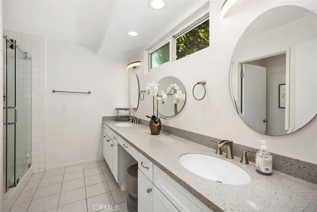 a bathroom with a double vanity sink and a mirror