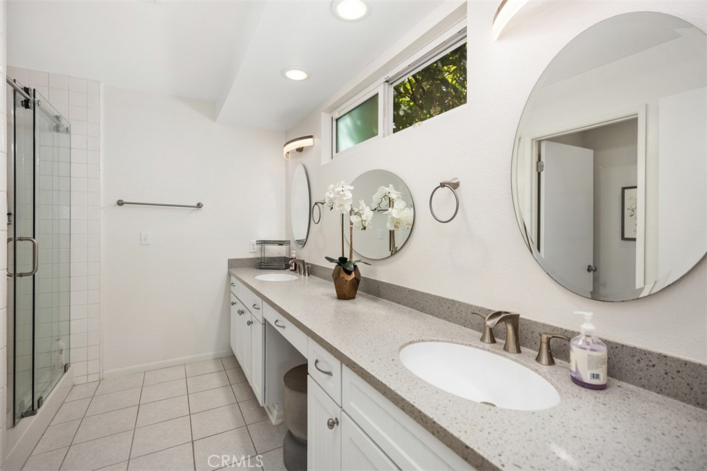 32321 Azores Road Dana Point, CA 92629 - Photo 15 of 30 a bathroom with a double vanity sink and a mirror
