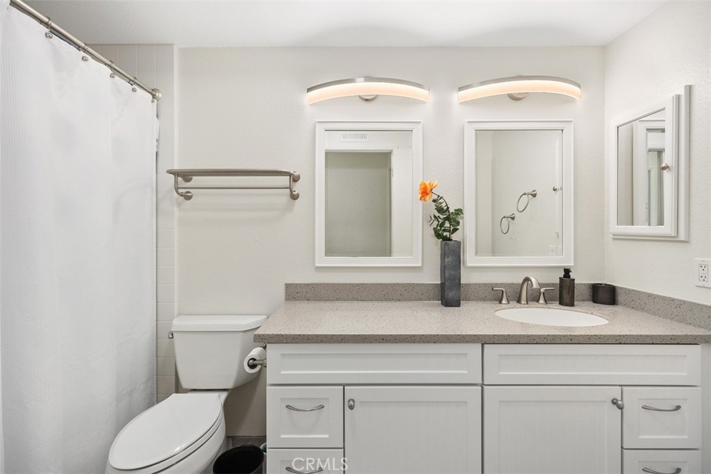 32321 Azores Road Dana Point, CA 92629 - Photo 17 of 30 a bathroom with a toilet sink and mirror