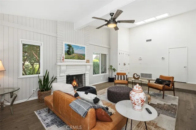 a living room with furniture a fireplace and a table