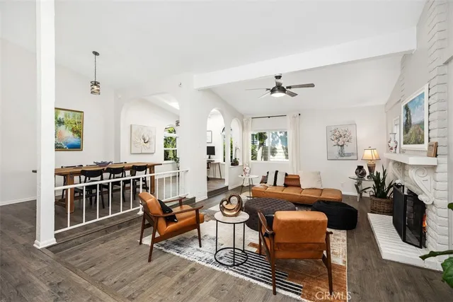 a living room with furniture a fireplace and a table