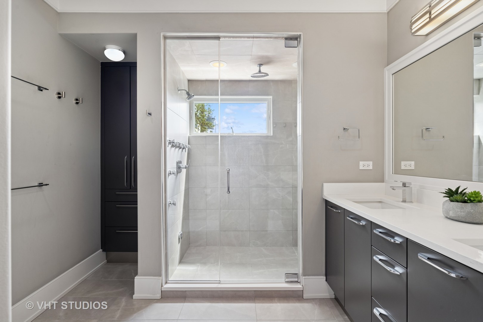 637 West Melrose Street, Unit 2 Chicago, IL 60657 - Photo 12 of 21 a bathroom with a shower sink and mirror
