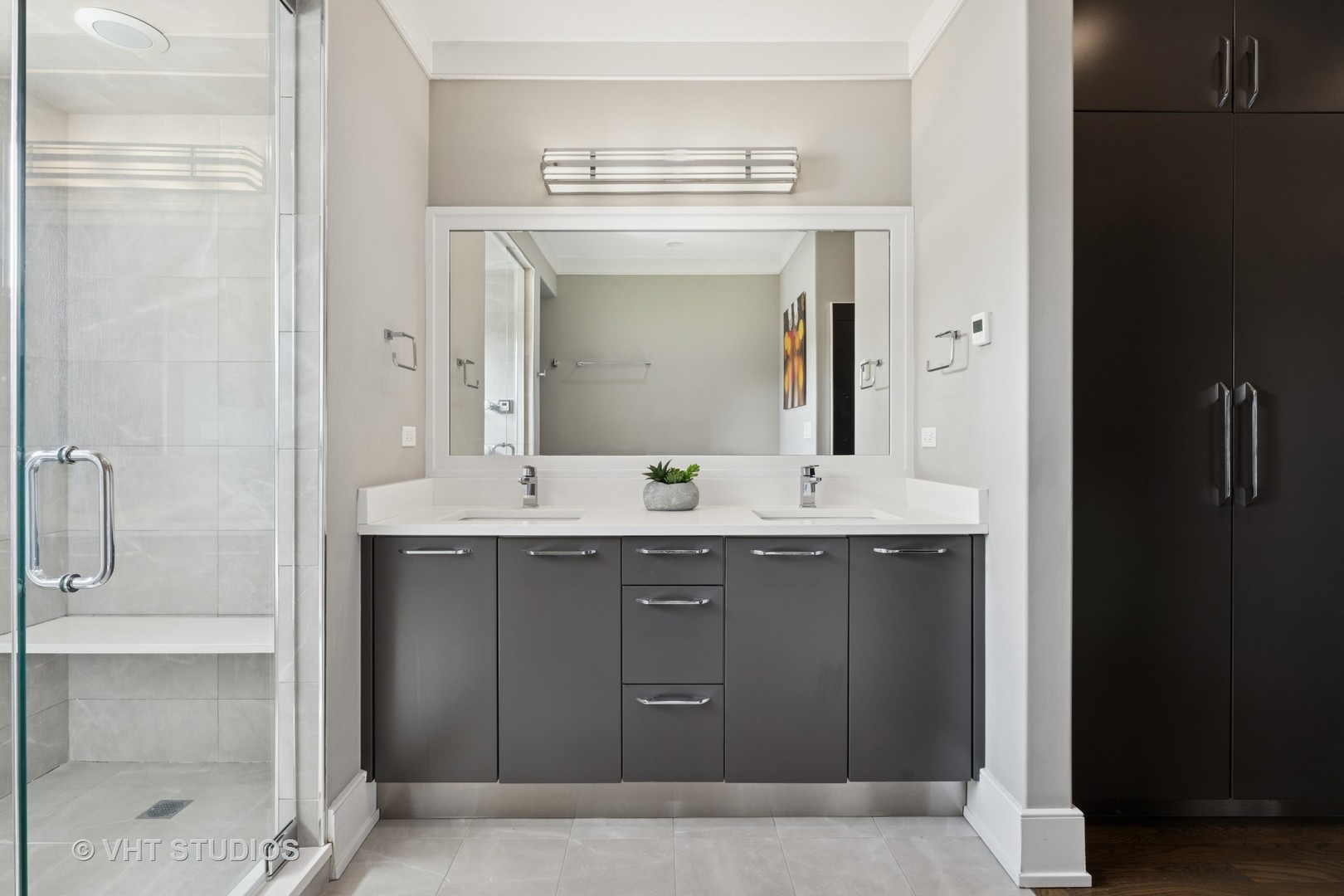 637 West Melrose Street, Unit 2 Chicago, IL 60657 - Photo 13 of 21 a bathroom with a granite countertop sink a mirror and a shower