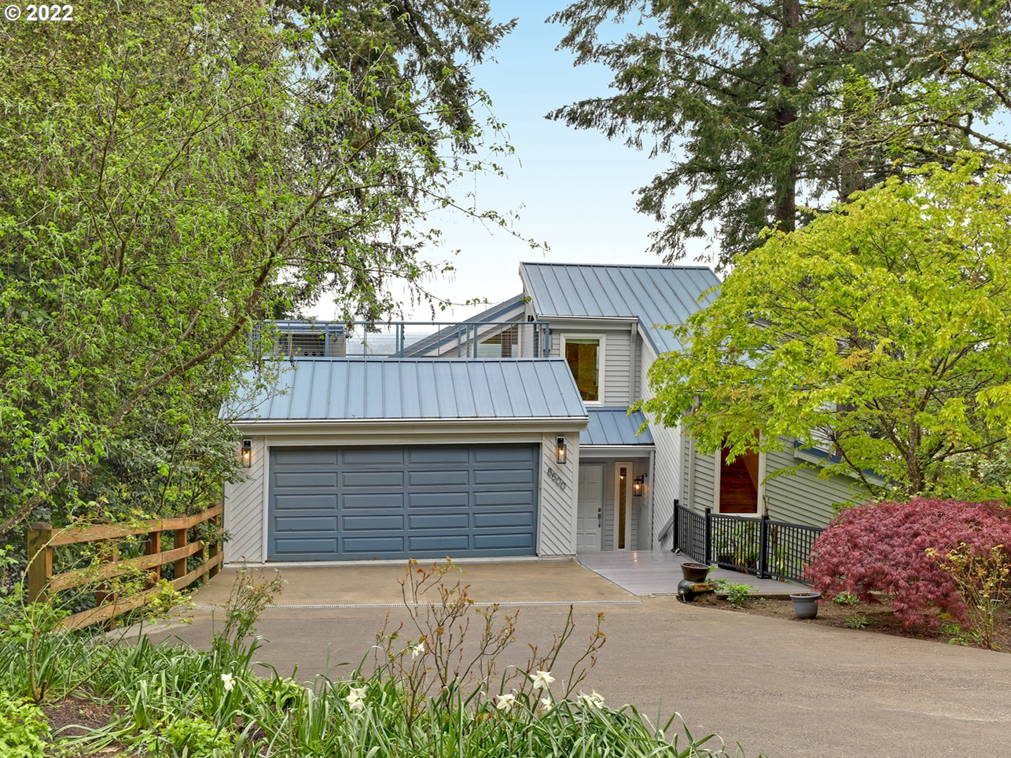 8500 Southwest Mapleridge Drive Portland, OR 97225 - Photo 1 of 30 a front view of a house with a garage