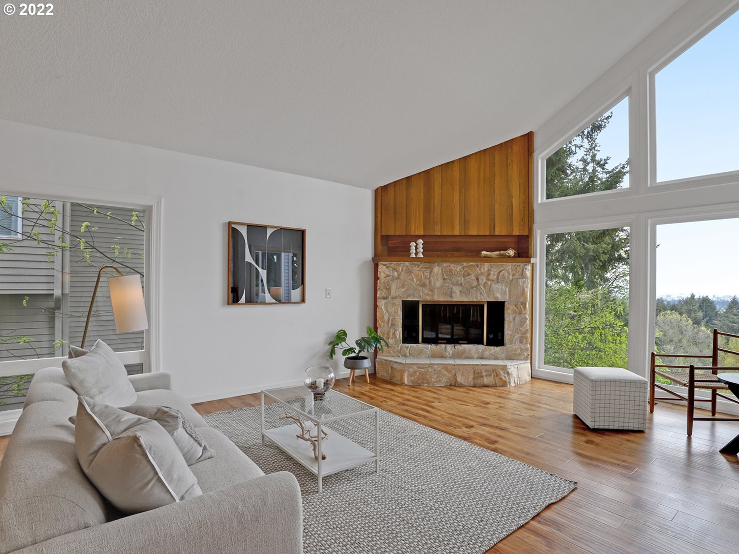 8500 Southwest Mapleridge Drive Portland, OR 97225 - Photo 11 of 30 a living room with furniture a fireplace and a large window