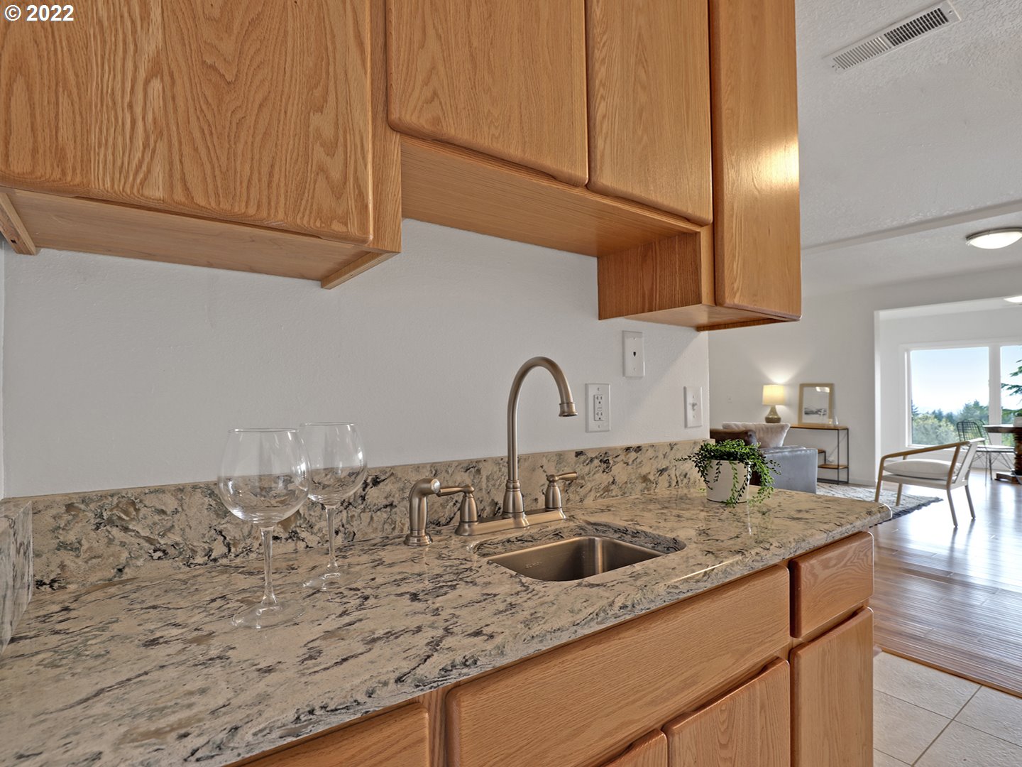 8500 Southwest Mapleridge Drive Portland, OR 97225 - Photo 19 of 30 a kitchen with granite countertop a sink and cabinets