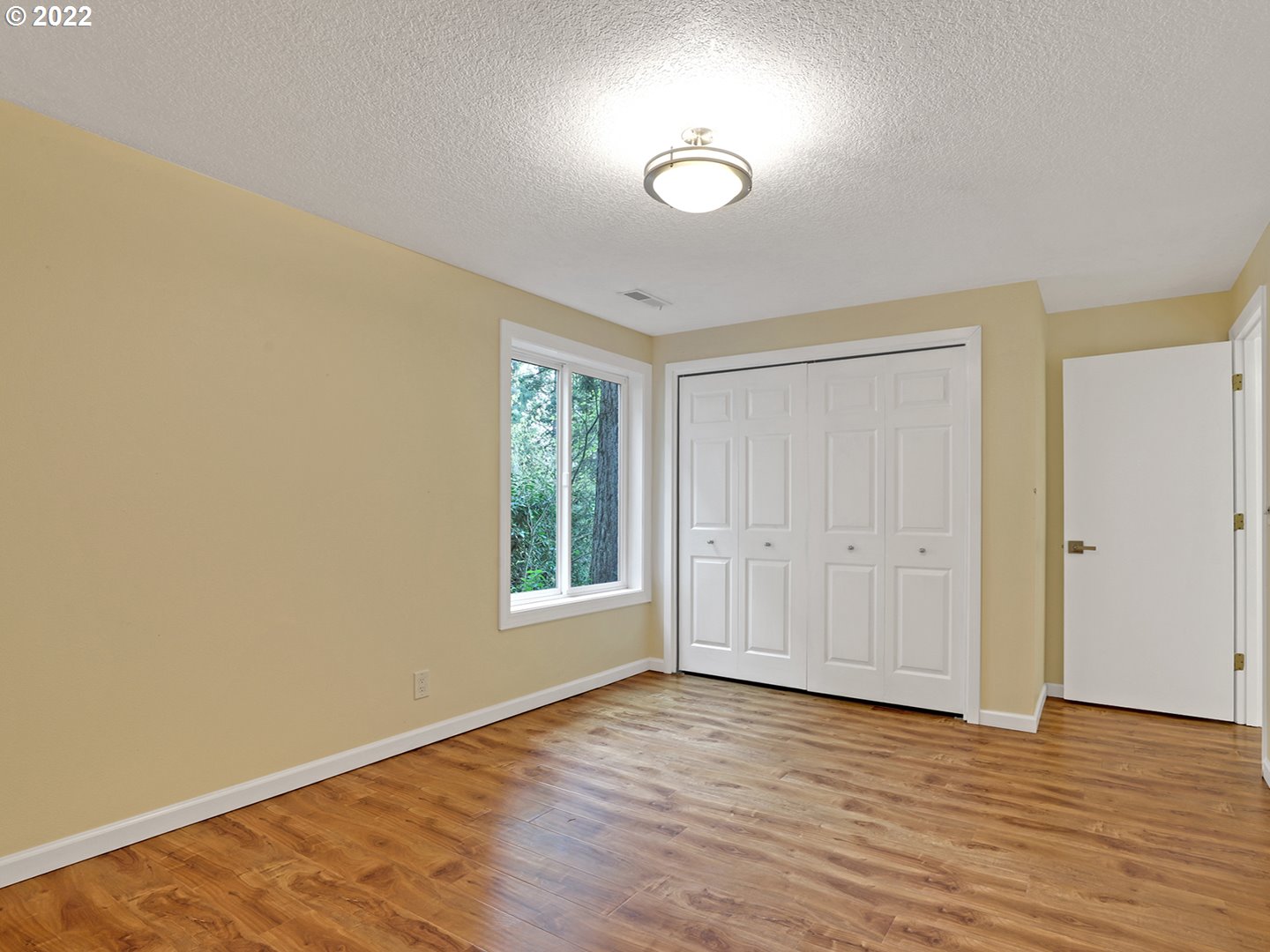 8500 Southwest Mapleridge Drive Portland, OR 97225 - Photo 21 of 30 a view of an empty room with wooden floor and a window