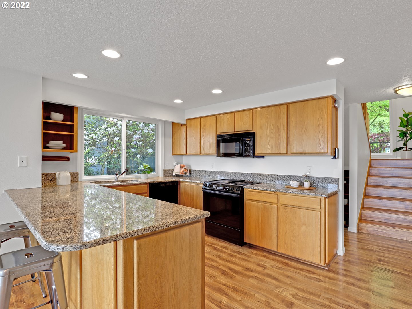 8500 Southwest Mapleridge Drive Portland, OR 97225 - Photo 5 of 30 a kitchen with stainless steel appliances granite countertop a stove top oven a sink and a refrigerator